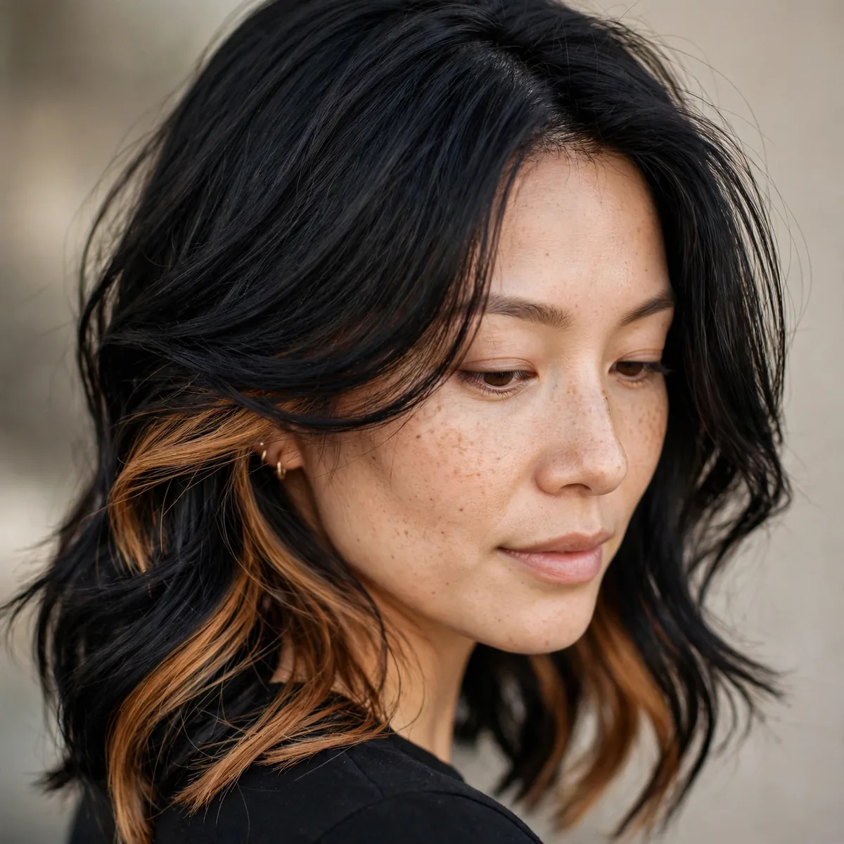 Black hair with caramel peekaboo highlights underneath